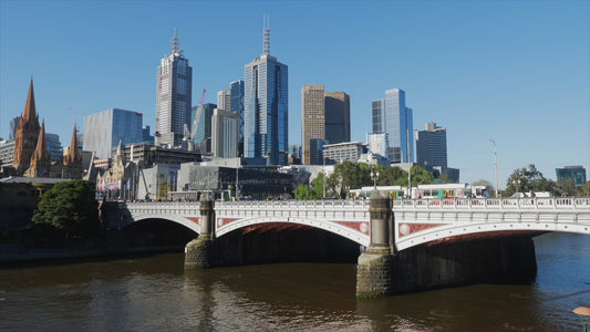 Princes Bridge - long shot of river flowing under and traffic over it HD